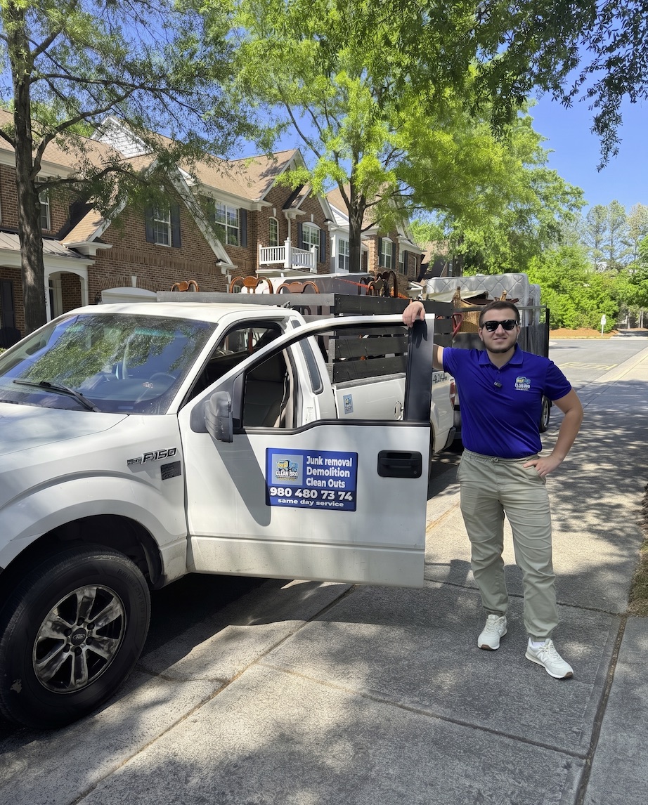 CleanBroServices team member standing beside the work truck before a junk removal job.